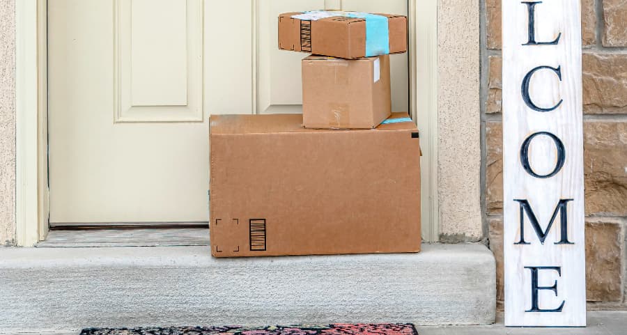 Boxes by the door of a residence with a welcome sign in Charlottesville